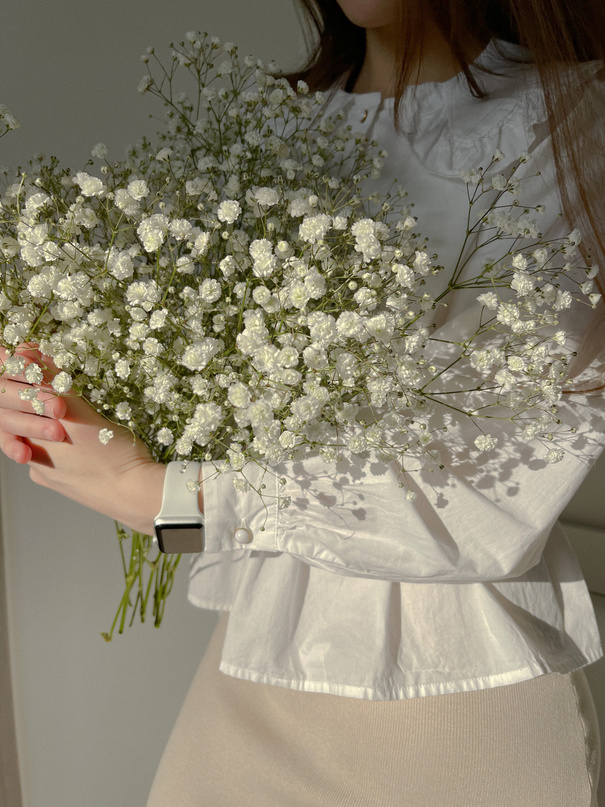 A Person Holding a White Flowers